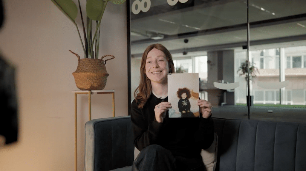 Katherine Pickles holding her childhood photo